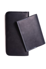 Handmade blue passport cover and black purse isolated on white background closeup. Stock photo of isolated handmade luxury accessories.