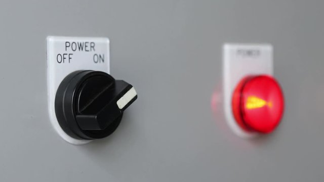 Close-up of hand turn on machine power switch 