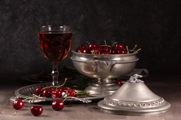 Vintage still life with ripe cherry and pewter