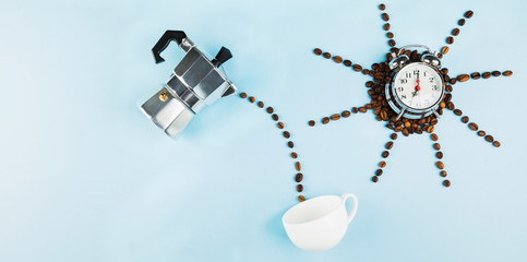 Sun made of coffee beans on blue background. Concept begins morning with coffee. Top view, copy space. Food background