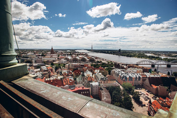 Red roofs of old Riga. Riga cityscape on a sunny summer day. City aerial view of the old town with the Dome Cathedral and the Daugava River in the city of Riga, Latvia