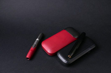 Electronic device on a black background. Modern cigarettes without harm to health. Copy space.