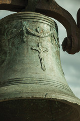 Fototapeta premium Close-up of bronze bell where can be seen details carved on the surface, at the Castle of Trujillo.