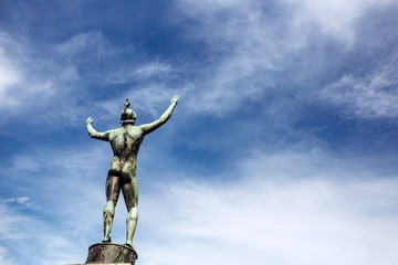 male sculpture against the sky. sculpture of a roman warrior. Gamla Stan, the oldest part of Stockholm, Sweden. Scandinavia, Northern Europe. Sunny weather with blue sky