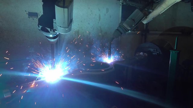 Welding robots movement in a car factory, automotive parts industry.