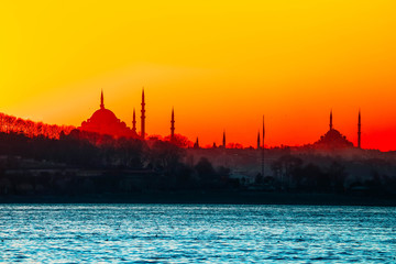 Istanbul city view silhouettes. Sunset in Bosphorus. Muslim mosque landscape.