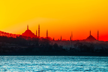 Fototapeta premium Istanbul city view silhouettes. Sunset in Bosphorus. Muslim mosque landscape.