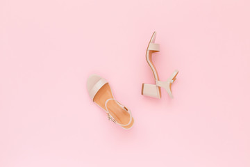 Pink heeled sandal on pink background. Flat lay, top view, trendy beauty female background.