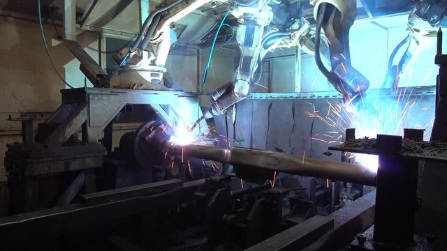 Welding robots movement in a car factory, automotive parts industry.