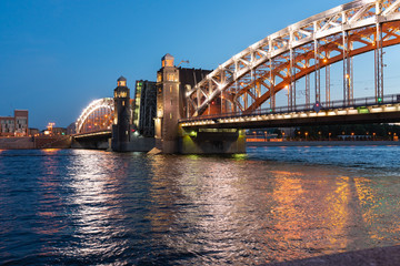 Bolsheokhtinsky bridge in St. Petersburg at night with open spans over the Neva.