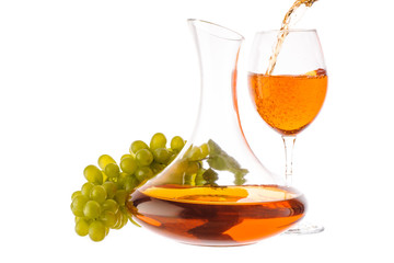 Amber wine. Wine in a glass and decanter near grapes. Wine is poured into a glass. Traditional Georgian wine according to ancient technology. Isolated on white background. Copy space. Close up.
