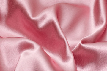 Delicate pink background silk fabric. Background, texture.