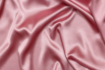 Delicate pink background silk fabric. Background, texture.