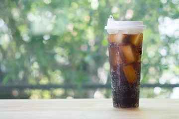 Refreshing black soda soft drinks in a plastic tall glass