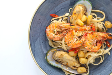 Closeup Spicy Spaghetti With Shrimps And Mussels on Plate and White Background .Thai Style.