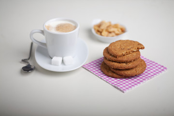 cup of coffee and cookies on table