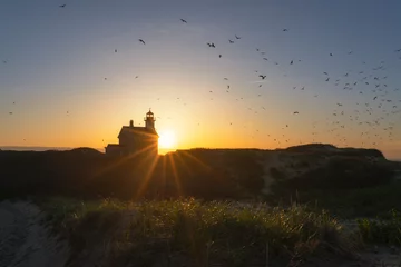 Wandaufkleber Silhouette of North Lighthouse at sunset on Block Island  © Michael