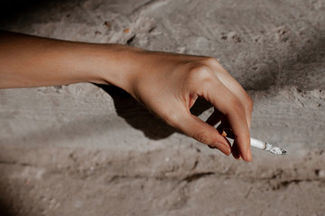 Woman smoking a cigarette. Cigarette smoke spread.