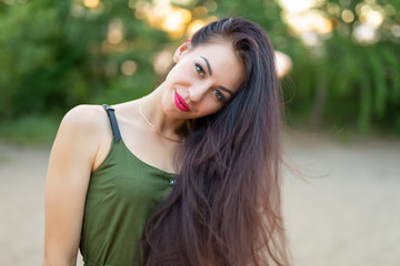 Fototapeta premium Brunette woman with high volume beautiful hair at nature