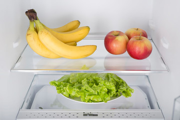 Open fridge full of fresh fruits and vegetables