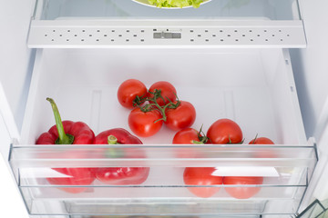 Open fridge full of fresh fruits and vegetables