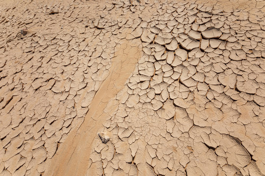 Track duct on cracked ground in a desert