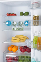 Open fridge full of fresh fruits and vegetables