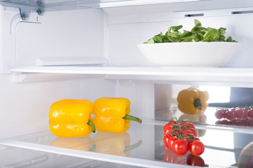 Open fridge full of fresh fruits and vegetables