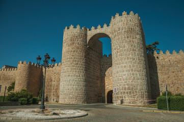 Fototapeta na wymiar San Vicente Gate with two towers in front of street at Avila