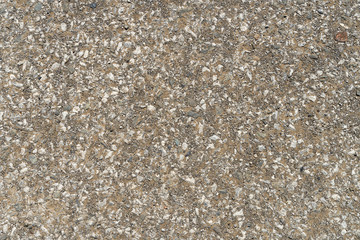Texture of gray asphalt with small stones. Background highway of grainy asphalt closeup.