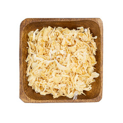 Dried onion in wooden bowl isolated on white