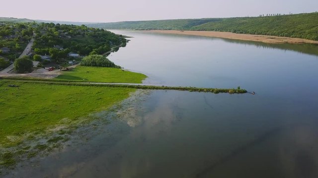 Flying over the river on a sunny summer day. Dniester river of Moldova republic.