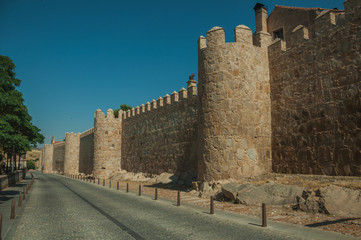 Pedestrian promenade beside large city wall at Avila