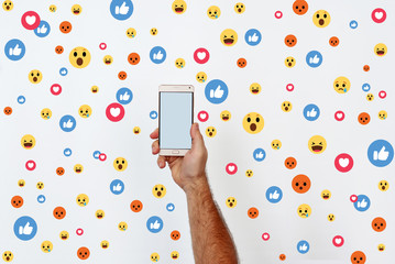 Male hand hold the phone, photography. Likes in social networks