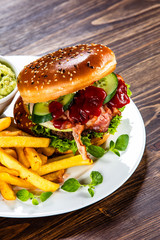 Tasty burger with chips served white plate