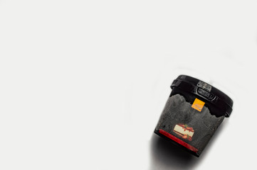 black plastic ice cream jar on a white background close-up