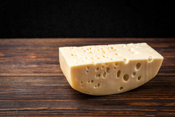 Cheese on dark wooden background