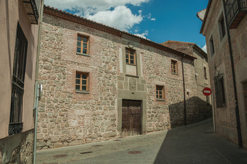 Fototapeta na wymiar Deserted alley and old building with wooden door at Avila