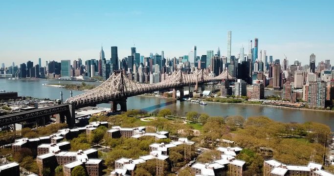 Aerial of Queensborough bridge and downtown manhattan and Queens rooftops