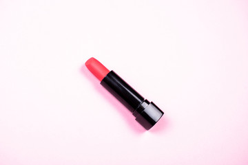 Red lipstick on pink background