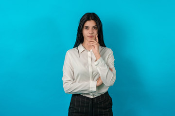 Attractive young girl close-up with big eyes. Business woman look at camera with serious face