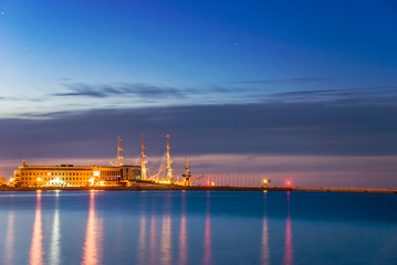 Harbor pier with ship and buildings