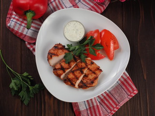 Grilled steak sliced pieces and vegetables on a plate