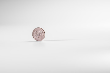 Dollar coin rotating on white background, concept of American economy.