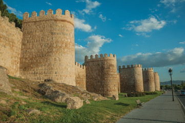 Fototapeta na wymiar Sidewalk and stone towers on the large wall of Avila