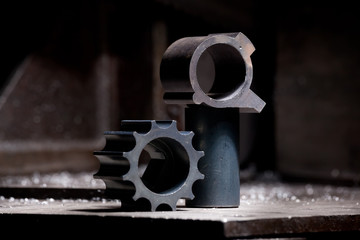 closeup of metal engine detail - steel gear on industrial background
