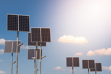 Solar panels on the pillars of led street lighting against the blue sky with clouds