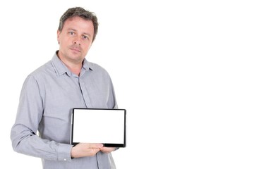 handsome man in grey blue shirt isolated on white background demonstrating white empty blank screen of computer tablet