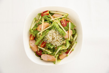 Sausage salad with cucumbers, tomatoes and onions