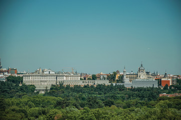 Fototapeta na wymiar Royal Palace and Almudena Cathedral with trees in Madrid